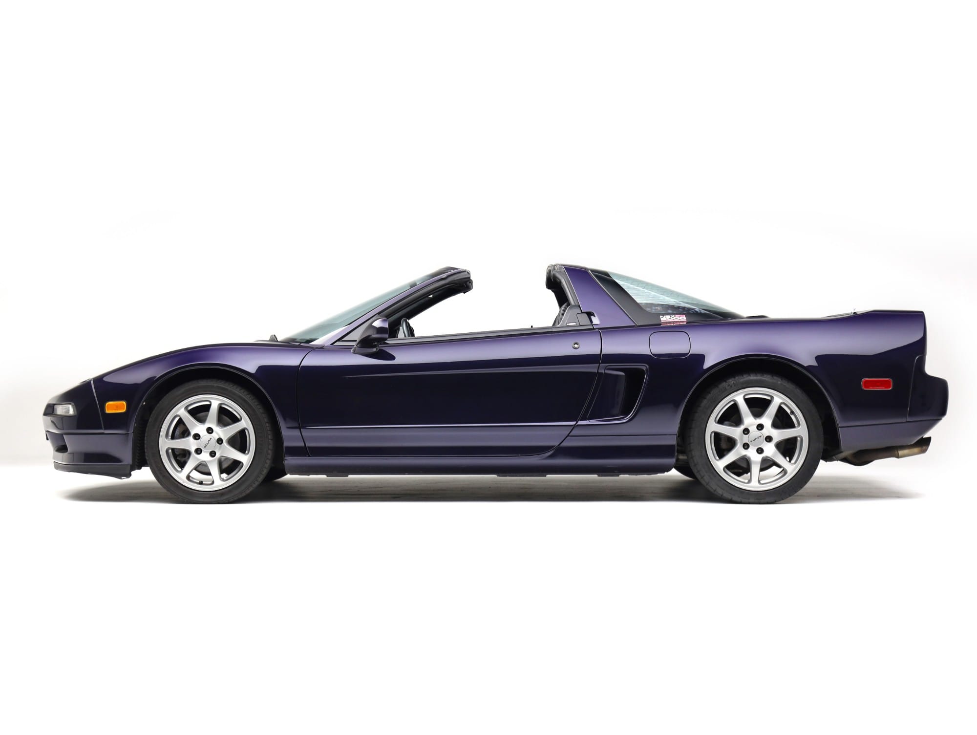 Acura NSX-T in dark purple pearl, side profile on a white studio background with the targa roof removed